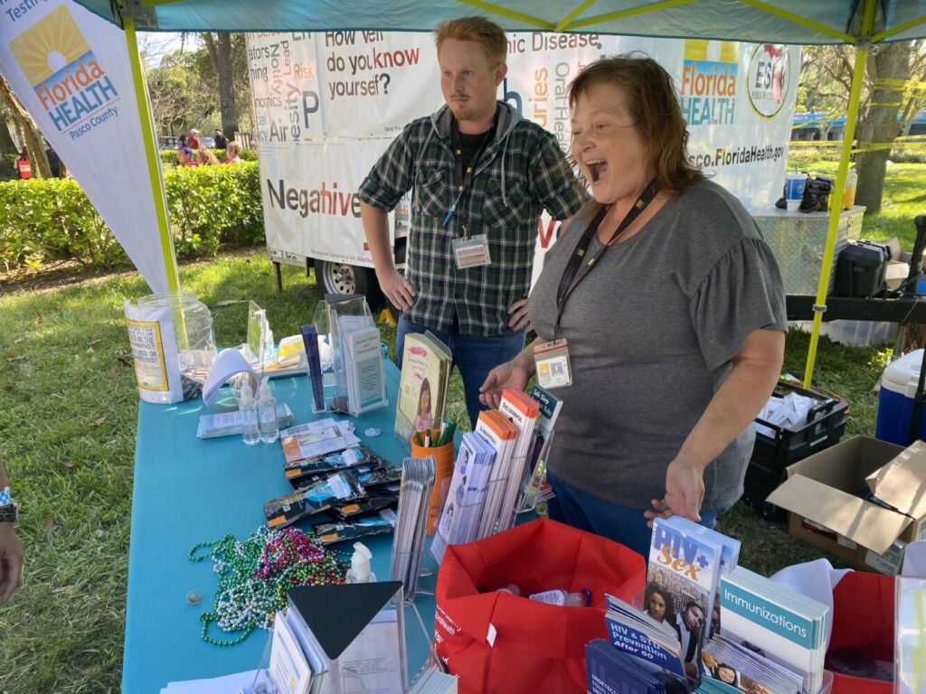 two volunteers working a Florida Health Pasco County booth